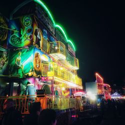 Illuminated building against sky at night