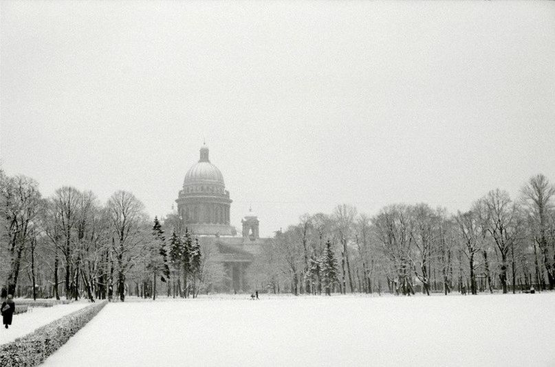 BARE TREES ON SNOW COVERED CITY AGAINST SKY