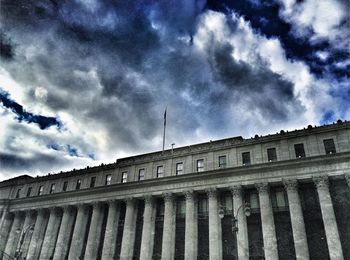 Low angle view of building against cloudy sky