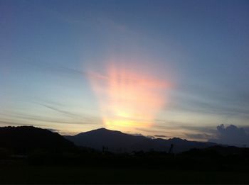 Scenic view of silhouette mountains against sky during sunset