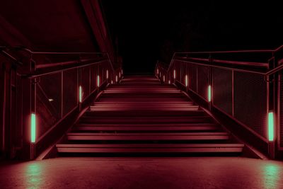 Low angle view of illuminated empty staircase in building at night