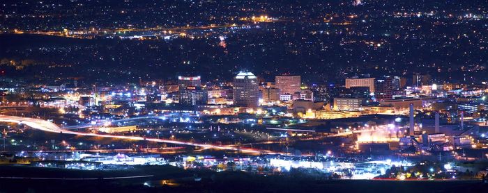 High angle view of illuminated buildings in city at night