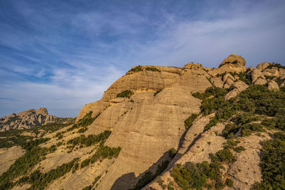 Rock formations on landscape against sky