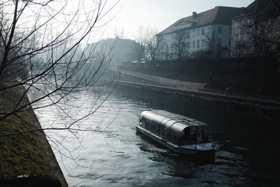 Boats in river with buildings in background