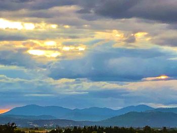 Scenic view of mountains against sky at sunset