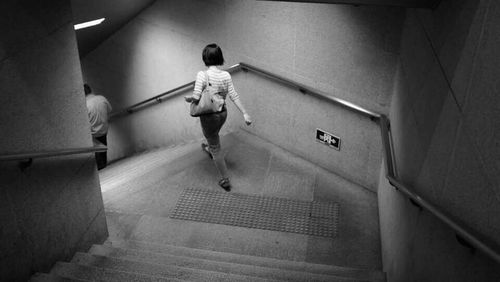 Full length of woman standing by railing