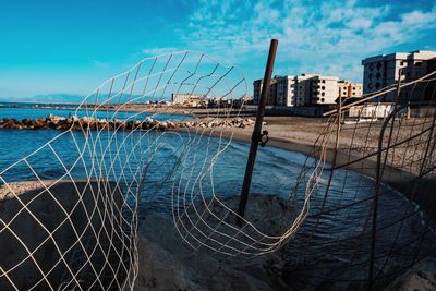 View of bridge over sea against buildings