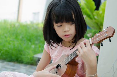 Portrait of a girl playing guitar