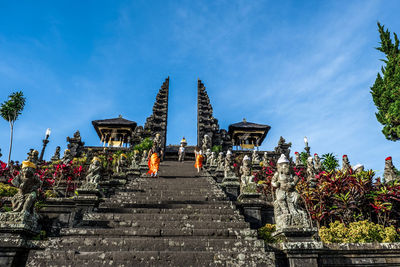 People at temple against sky