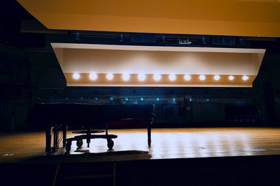 Empty bench in illuminated room