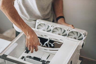 A detail-oriented computer technician, engaged in the delicate process of hardware assembly