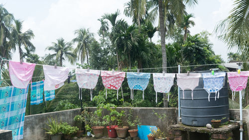 Clothes drying on clothesline against sky