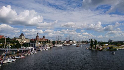 View of town by river against sky