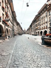 Surface level of footpath amidst buildings in city