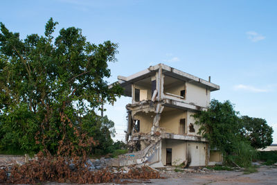 Low angle view of abandoned building against sky