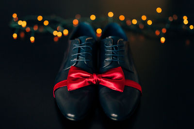 Close-up of red shoes in box against black background