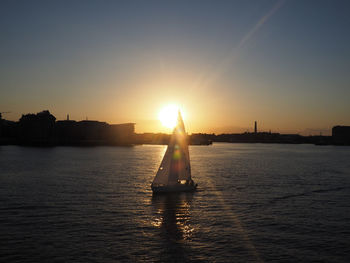 Silhouette of man in sea at sunset