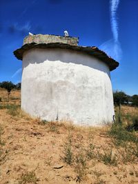 Built structure on field against sky