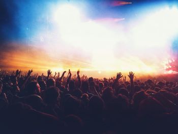 Crowd enjoying illuminated music concert at night