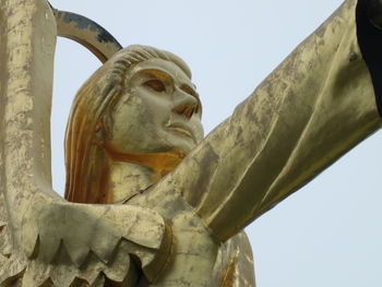 Low angle view of statue against sky