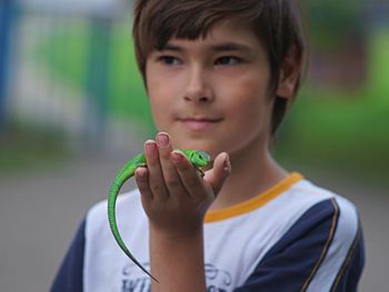 Portrait of boy holding leaf