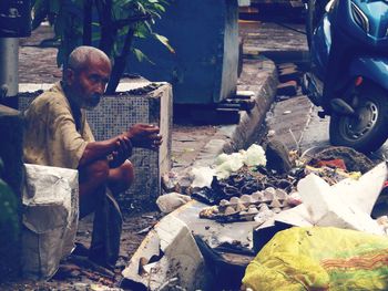 Man sitting at market stall