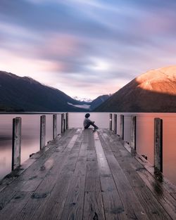 Person sitting on jetty