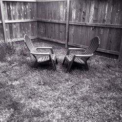 Empty bench on grassy field