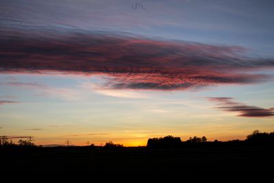 Silhouette landscape against sky during sunset