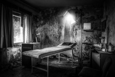 Empty chairs and table in abandoned building