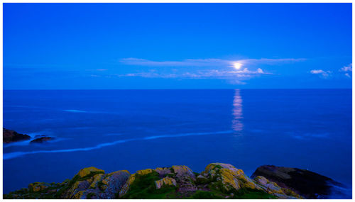 Scenic view of sea against blue sky