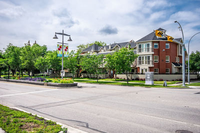 Street by buildings against sky