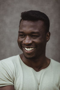 Close-up of happy man looking away while standing outdoors