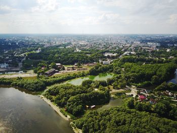 High angle view of river amidst city against sky