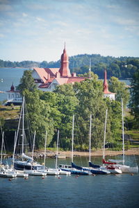 Sailboats in temple by trees against sky