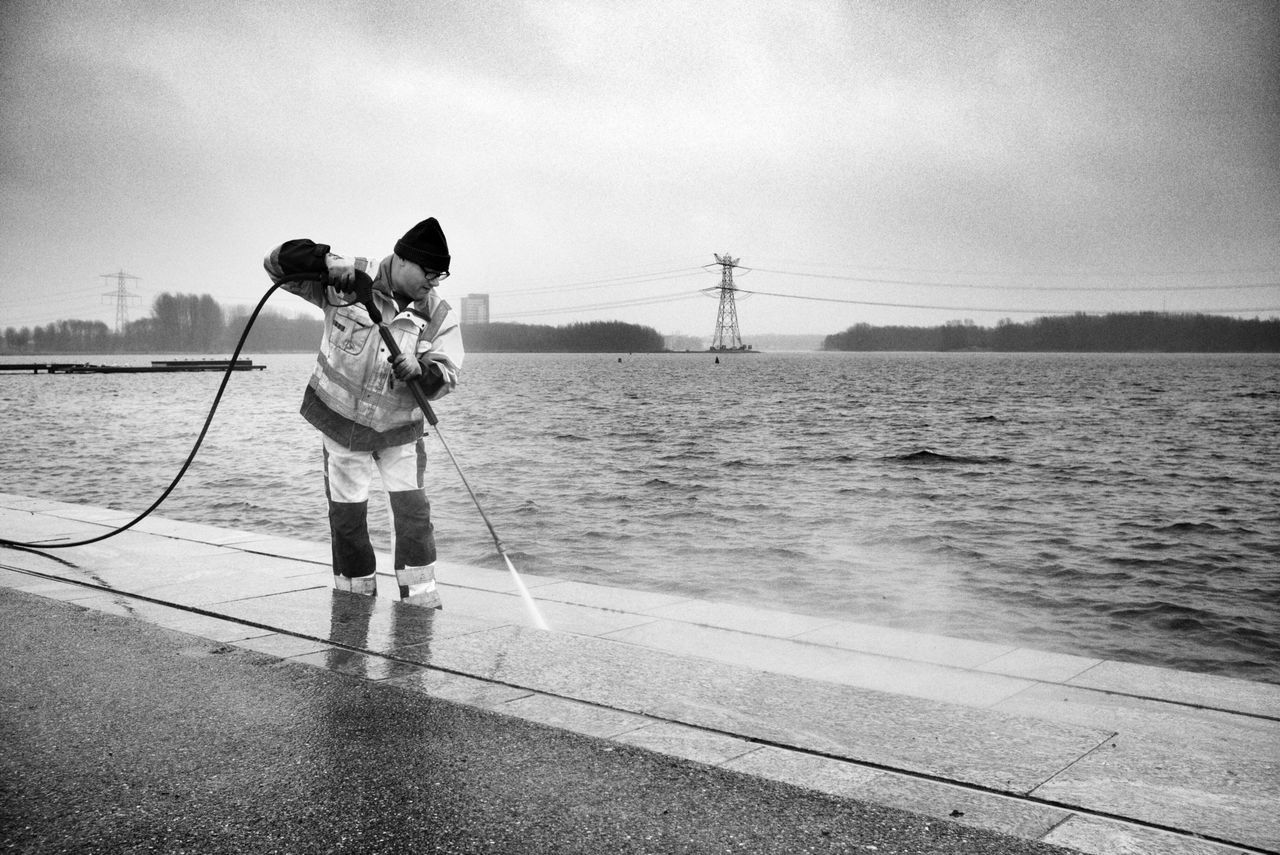 water, sky, full length, sea, transportation, lifestyles, men, rear view, leisure activity, standing, nautical vessel, mode of transport, casual clothing, day, outdoors, nature, travel