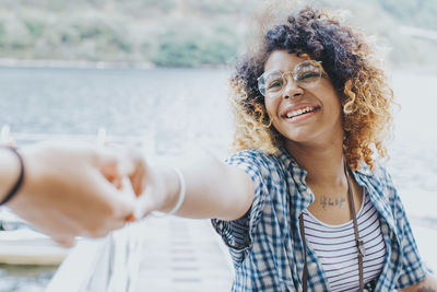 Portrait of smiling woman standing on beach