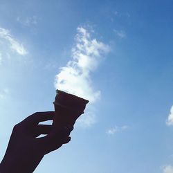 Low angle view of silhouette man standing against cloudy sky