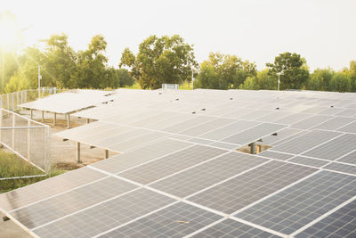 Solar panels on field against sky