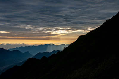 Scenic view of silhouette mountains against sky during sunset