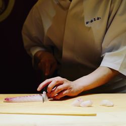 Close-up of man with hands on table