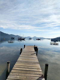 Pier over lake against sky