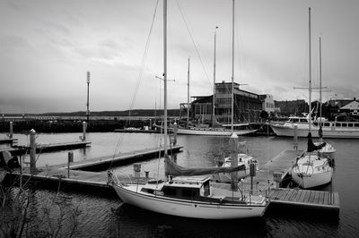 Boats moored in river against built structure