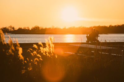 Scenic view of lake against sky during sunset