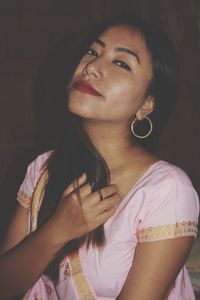 Close-up portrait of young woman at home