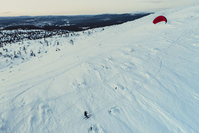 High angle view of person snowboarding on field