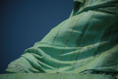 Low angle view of statue against blue sky