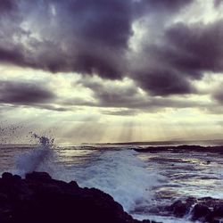 Scenic view of sea against cloudy sky