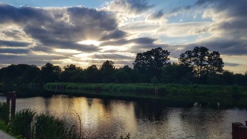 Scenic view of lake against sky at sunset
