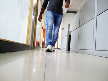 Low section of woman standing on tiled floor